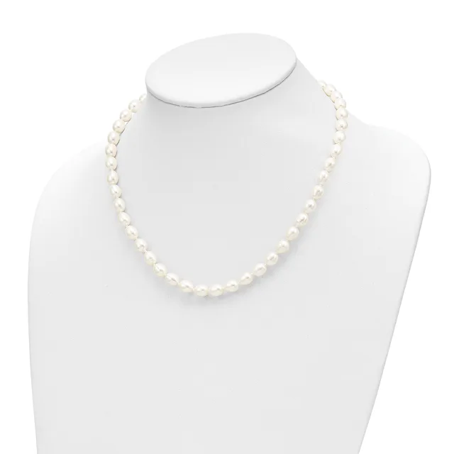 A strand of white pearl beads displayed on a white mannequin neck form against a white background.