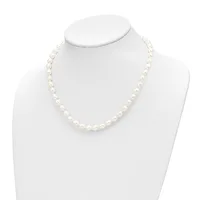 A strand of white pearl beads displayed on a white mannequin neck form against a white background.