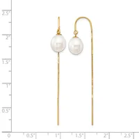 Two gold threader earrings with white pearl drops, displayed against a ruler showing they measure approximately two inches in length.