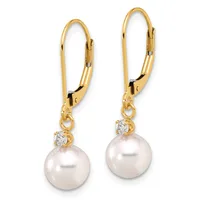 A pair of gold lever-back earrings, each featuring a white pearl with a small diamond accent, suspended from gold wires.