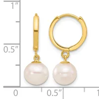 Pair of gold hoop earrings with pearl drops, shown from front and side view next to a measurement scale indicating approximately one inch in length.