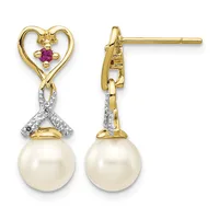 Gold heart stud earrings with purple gemstones, diamond accents, and dangling cream-colored pearl drops, shown from front and side views.