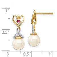Pair of gold drop earrings with heart-shaped tops set with ruby and diamonds, suspended pearl bottoms, shown against a measurement scale.