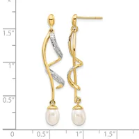 Two-tone drop earrings with twisted gold and diamond-accented upper sections suspending white pearl drops, shown on a measurement scale indicating approximately 1.5 inches in length.