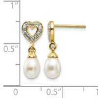 Gold-tone heart stud earrings with diamond accents and dangling white pearl drops, shown against a measurement scale.