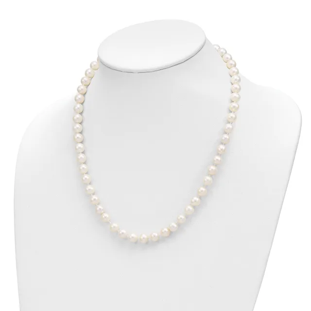 A strand of white pearl beads displayed on a white mannequin bust against a white background.