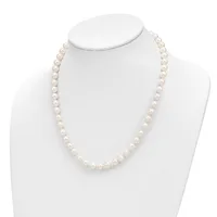 A strand of white pearl beads displayed on a white mannequin bust against a white background.