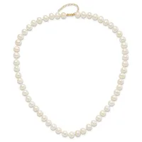 A strand of round cream-colored pearls with a gold-tone chain clasp, displayed as a closed necklace.