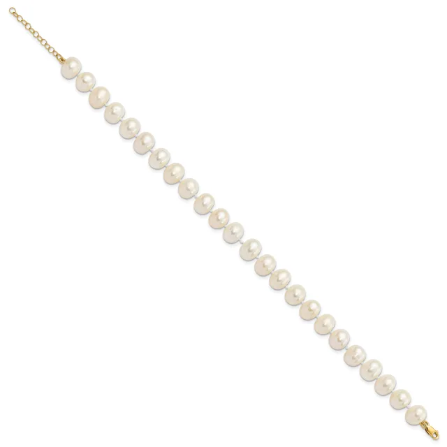 A gold chain bracelet with evenly spaced white pearl beads strung along its length, displayed diagonally against a white background.