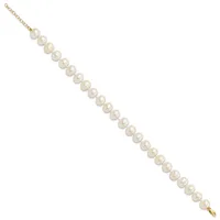 A gold chain bracelet with evenly spaced white pearl beads strung along its length, displayed diagonally against a white background.