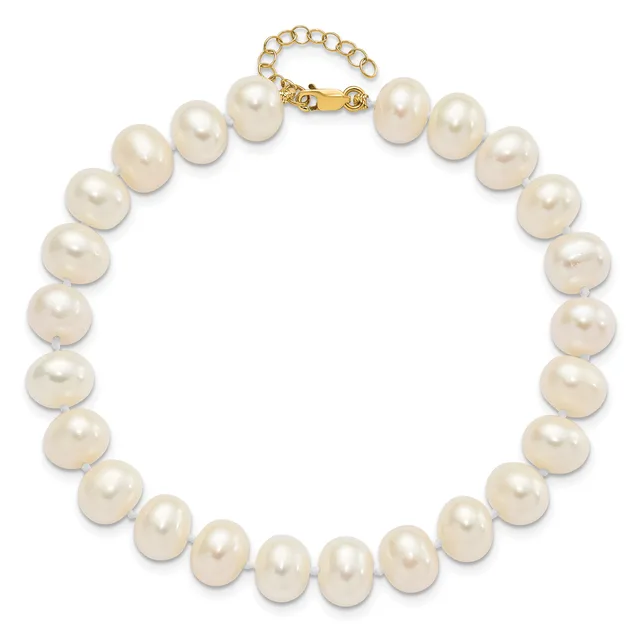A strand of round cream-colored pearls connected by a gold-toned clasp with an adjustable chain extender.