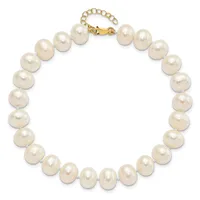 A strand of round cream-colored pearls connected by a gold-toned clasp with an adjustable chain extender.
