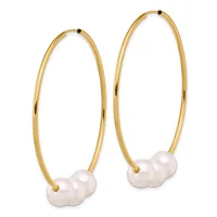A pair of gold hoop earrings with white pearl clusters suspended at the bottom, shown against a white background.