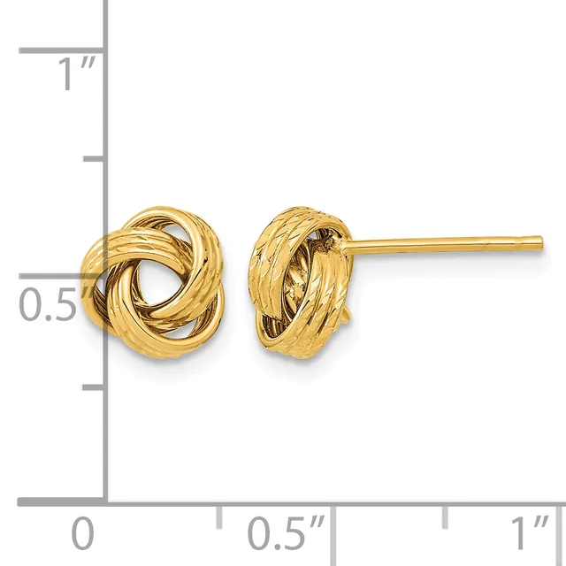 Pair of gold-toned twisted knot stud earrings displayed on a ruler showing approximately half-inch diameter size.