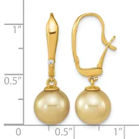 Pair of gold drop earrings with golden pearl spheres suspended from polished gold stems set with small diamonds, shown next to a ruler for scale.