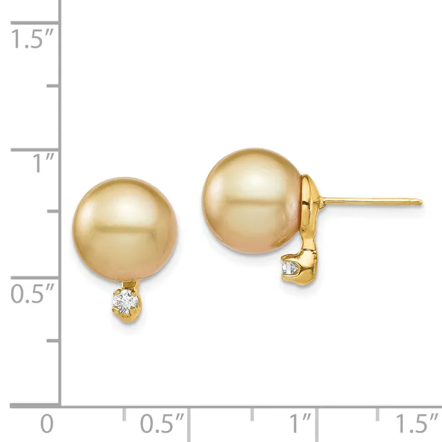 Two champagne-colored pearl stud earrings with small diamond accents, displayed against a measurement scale showing approximately one inch in height.
