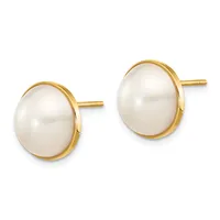 A pair of gold stud earrings, each featuring a white pearl set in a bezel mounting with a polished gold finish.