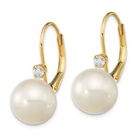 Pair of gold leverback earrings with round white pearls and small round diamond accents on top.