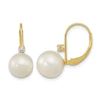 Pair of gold leverback earrings with cream-colored pearl drops and small diamond accents at the top, shown from front and side angles.