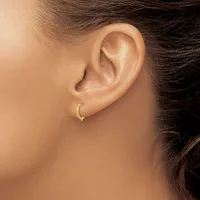 A person wearing a small curved gold hoop earring in their lower earlobe, shown in profile against a neutral background.