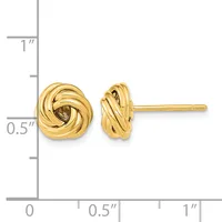 A pair of gold twisted knot stud earrings displayed next to a ruler showing their size as approximately half an inch in diameter.