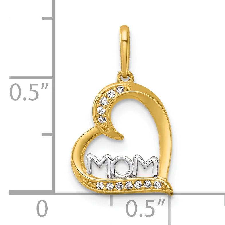 Gold heart-shaped pendant with "MOM" text in the center, decorated with cubic zirconia stones along the curved edges, shown against a measurement scale.