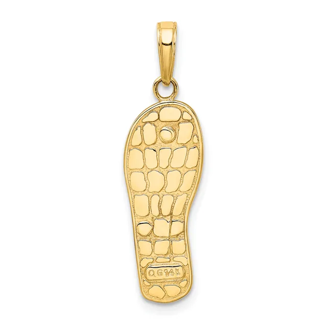 Gold pendant in the shape of a footprint with a textured crocodile or alligator skin pattern and a small stamped hallmark on the sole.