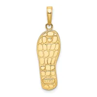 Gold pendant in the shape of a footprint with a textured crocodile or alligator skin pattern and a small stamped hallmark on the sole.