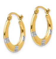 A pair of gold hoop earrings with white gold accents, featuring oval loops with textured bands, displayed against a white background.