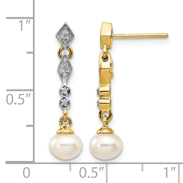 A pair of yellow gold drop earrings with diamond-set geometric tops and pearl bottoms, displayed against a measurement scale showing approximately one inch in length.