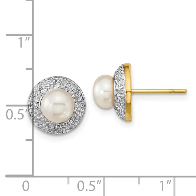 Two round stud earrings featuring white pearls surrounded by pavé-set diamonds in white metal with gold posts, displayed next to a measurement scale.