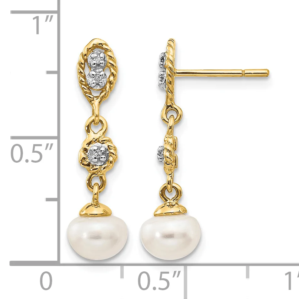 Pair of gold drop earrings with diamond-set oval tops, connected chains, and white pearl bottoms, displayed against a measurement scale.