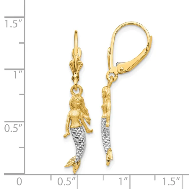 Two gold mermaid charm earrings with diamond-textured tails, shown next to a ruler indicating approximately one inch in length.