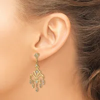 A gold chandelier-style earring with small round gemstones hangs from a stud, shown worn on a person's ear.
