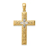 A gold cross pendant with ornate filigree detailing and a white gemstone accent at the center, displayed against a white background.