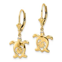 A pair of gold turtle-shaped dangle earrings with lever backs, featuring cutout details on the shells and small diamond accents on the connectors.