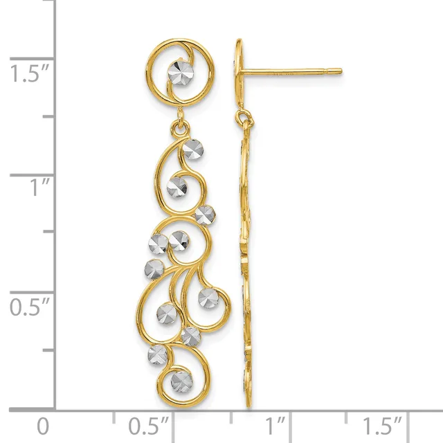 Pair of gold-tone dangle earrings with scrolled designs accented by faceted silver-tone stones, displayed against a measurement scale showing approximately 1.5 inches in length.