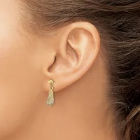 A woman wearing a gold teardrop-shaped dangle earring with a textured surface and small post closure, shown from the side view of her ear.