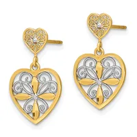 Pair of gold heart-shaped drop earrings with ornate filigree tops and larger heart pendants featuring cross designs with diamond accents.