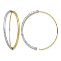 A pair of two-tone hoop earrings with white and yellow gold textured finishes shown from front and side angles.