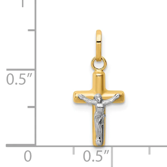 Two-tone gold cross pendant with white gold crucifix figure, displayed against a measurement scale showing approximately half inch width.