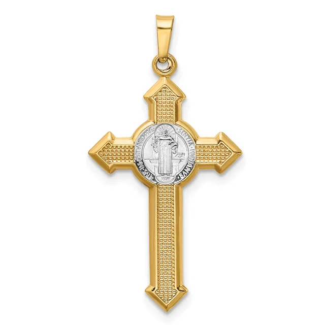 A gold cross pendant with a textured finish and a silver-toned oval medallion at its center featuring a standing religious figure.