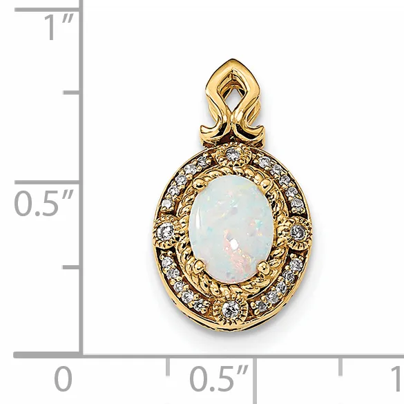 Gold pendant with ornate filigree frame surrounding a pale blue oval opal stone, with a decorative bail loop, shown against a measurement scale.