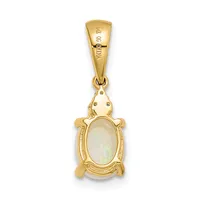 A gold pendant shaped like a turtle with an oval opal stone set in the center of its shell, suspended from a gold bail.