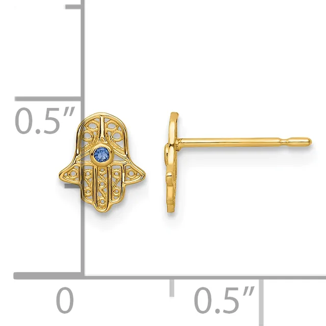 Gold hamsa hand stud earrings with diamond and sapphire accents, shown front and side view with measurement scale indicating approximately 0.5 inches in height.