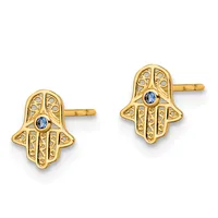 Pair of gold-toned hamsa hand stud earrings with filigree detailing and small blue sapphire stones in the center, shown from the front on a white background.