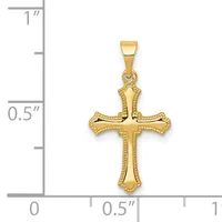 Gold cross pendant with decorative beaded borders and flared ends, shown next to a ruler for scale.