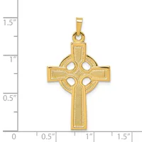 A gold Celtic cross pendant with four circular cutouts arranged in a cross pattern, shown next to a measurement scale indicating it is approximately one inch wide.
