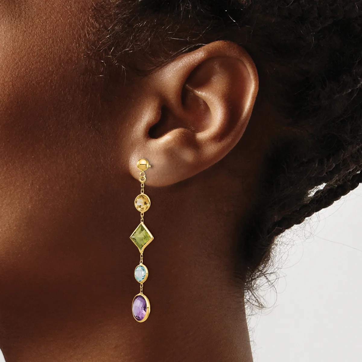 A gold dangle earring with round citrine, peridot diamond, opal, and amethyst stones hanging from a post worn on a person's ear.