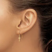 A person wearing gold cross earrings on threader-style hooks, shown from the side profile of their ear and neck.